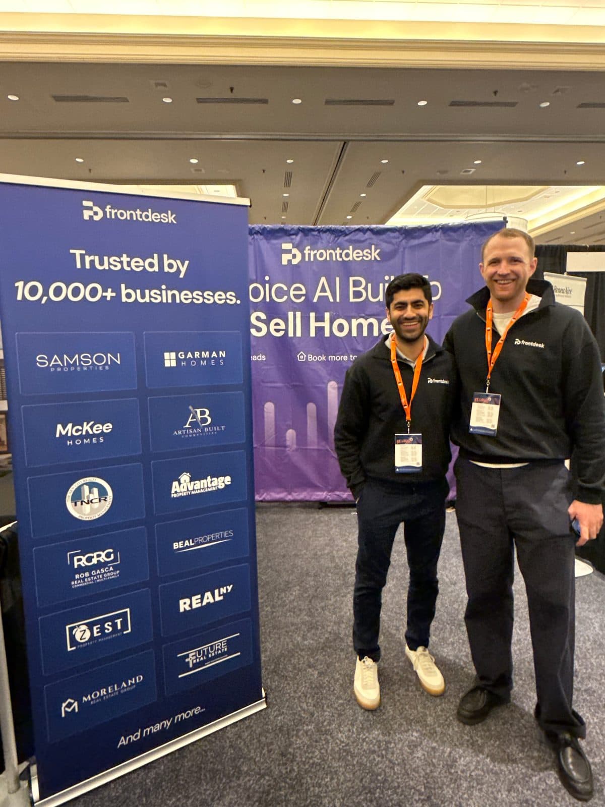 Frontdesk booth with a "Trusted by 10,000+ businesses" banner and customer logos